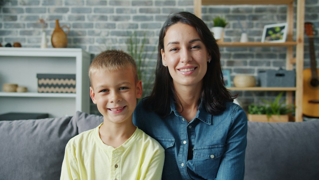 A mother and child smiling together at home